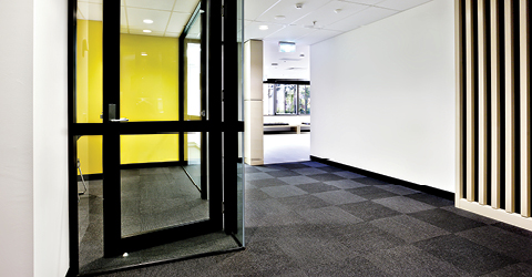 Front entrance of a building with black carpet