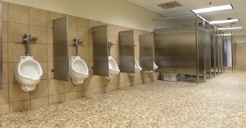 Boys bathroom showing urinals and bathroom stalls